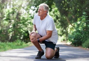 Can You Walk With an ACL Injury? Old man running and having pain in his knee