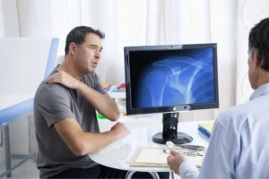 Patient getting his shoulder checked by an orthopedic doctor