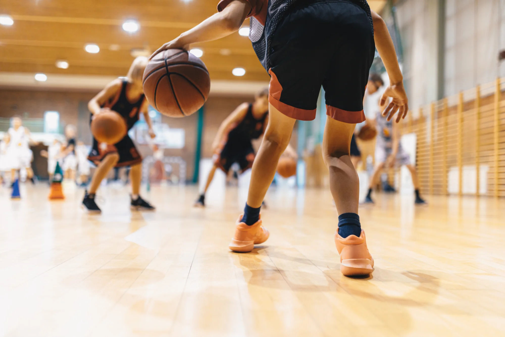 Young kid playing basketball with knee problems