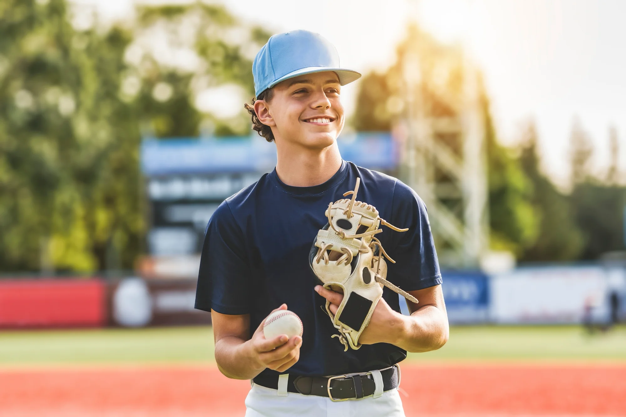 Teenager playing baseball